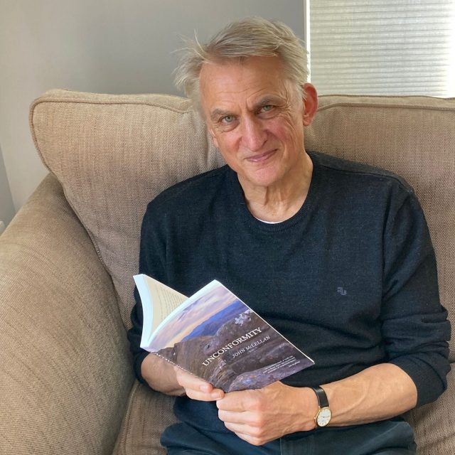 Author John McLellan holds a copy of his latest book